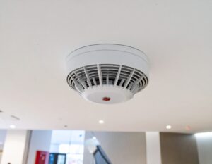 Fire detection alarm on ceiling of modern building - Fire Buyer